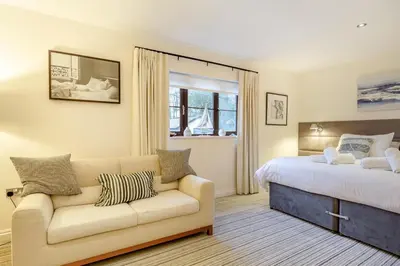 a bedroom with a couch and a bed and a window at 2 Bed in Tywardreath oc-d34709 in Tywardreath