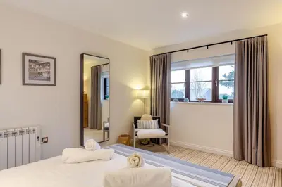 a bedroom with two beds and a mirror at 2 Bed in Tywardreath oc-d34709 in Tywardreath