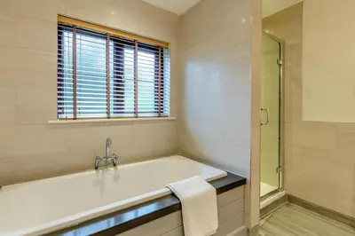 a bathroom with a bath tub and a window at 2 Bed in Tywardreath oc-d34709 in Tywardreath