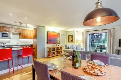 a kitchen and living room with a table and chairs at 2 Bed in Tywardreath oc-d34709 in Tywardreath
