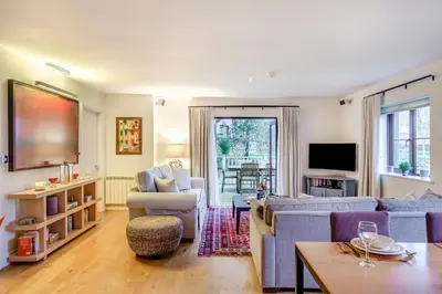 a living room with a blue couch and chairs at 2 Bed in Tywardreath oc-d34709 in Tywardreath