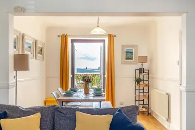 a living room with a table and a window at 2 Bed in Newquay oc-j32859 in Newquay