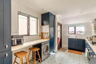 a kitchen with blue cabinets and a washer and dryer at 2 Bed in Newquay oc-j32859 in Newquay