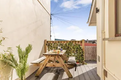 a wooden table on the balcony of a house at 2 Bed in Newquay oc-j32859 in Newquay
