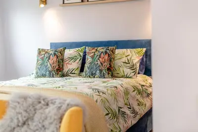 a couch with tropical pillows in a room at 1 Bed in Newquay oc-l28083 in Newquay