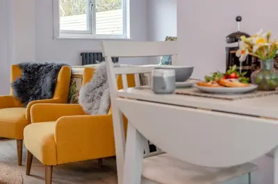 a kitchen with orange chairs and a table with food on it at 1 Bed in Newquay oc-l28083 in Newquay
