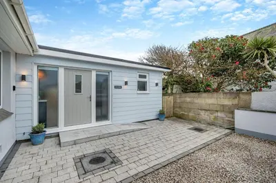 a home with a white garage with a patio at 1 Bed in Newquay oc-l28083 in Newquay