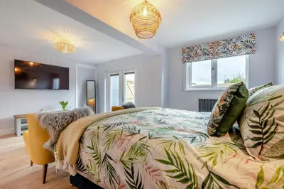 a bedroom with a bed with a colorful comforter at 1 Bed in Newquay oc-l28083 in Newquay