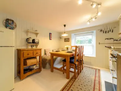 a small kitchen with a table and a refrigerator at Holiday Home Zion by Interhome in Gorran Haven