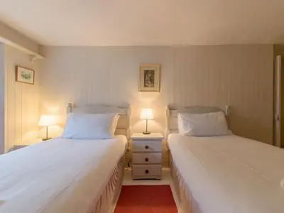 two beds in a small room with two lamps at Holiday Home Zion by Interhome in Gorran Haven