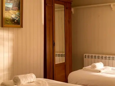 two beds in a room with towels on them at Holiday Home Zion by Interhome in Gorran Haven