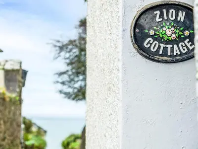 a sign on the side of a building at Holiday Home Zion by Interhome in Gorran Haven
