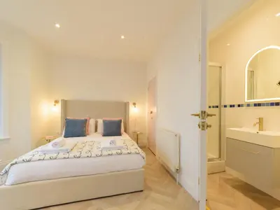 a bedroom with a large bed and a sink at Apartment No-4 Ocean Heights by Interhome in Mevagissey