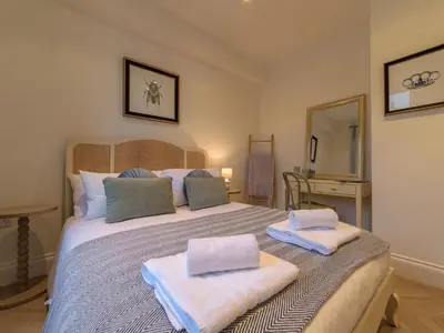 a bedroom with a large bed with towels on it at Apartment No-4 Ocean Heights by Interhome in Mevagissey