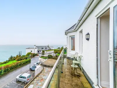 a balcony with a view of the ocean at Apartment No-4 Ocean Heights by Interhome in Mevagissey