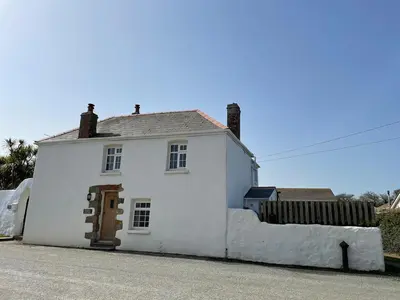 a white house on the side of a street at Cornwall Coastal Cottage - Beautiful & Stunning in Perranporth