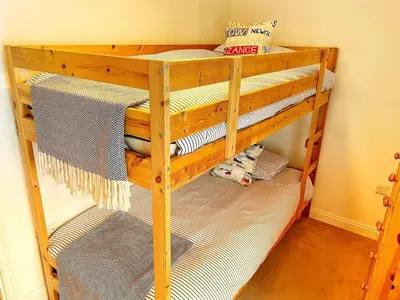 a wooden bunk bed in a room at Cornwall Coastal Cottage - Beautiful & Stunning in Perranporth