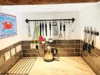 a kitchen counter with a tea kettle and utensils at Cornwall Coastal Cottage - Beautiful & Stunning in Perranporth