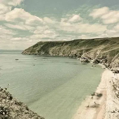 a beach with a bunch of boats in the water at Tredethick Farm Cottages in Lostwithiel