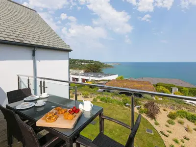 a table with a plate of food on a balcony at Mid Air in St Ives