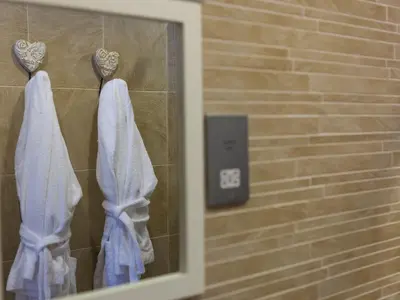 a mirror in a bathroom with towels on a wall at Mid Air in St Ives