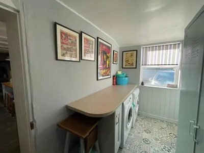 a laundry room with a counter and a washing machine at Sandown 4 bedroom house St Teath in Saint Teath