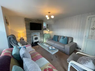 a living room with a couch and a table at Sandown 4 bedroom house St Teath in Saint Teath