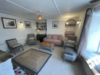 a living room with a couch and chairs and a table at The Brewhouse Boscastle Harbour in Boscastle