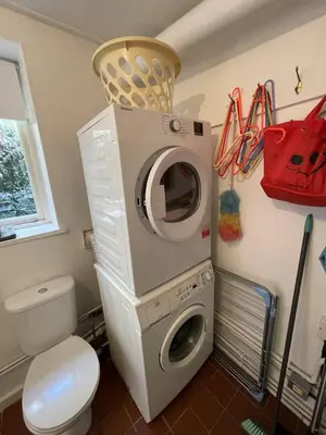 a washing machine in a bathroom with a toilet at The Brewhouse Boscastle Harbour in Boscastle