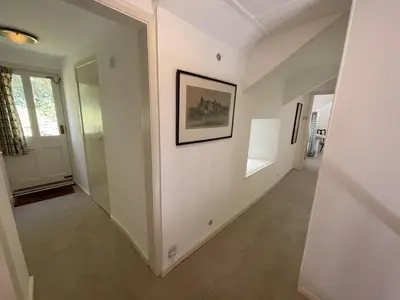 a hallway of a home with a painting on the wall at The Brewhouse Boscastle Harbour in Boscastle