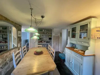 a kitchen with a wooden table in a room at Sandown St Teath 3 bed sleeps 6 in Saint Teath