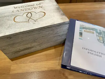 a book sitting on a table next to a book at Sandown St Teath 3 bed sleeps 6 in Saint Teath
