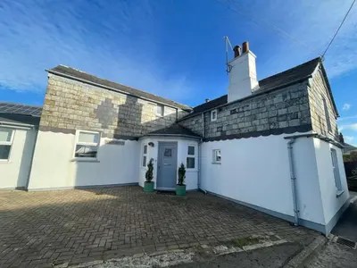 a large white house with a white garage at Sandown St Teath 3 bed sleeps 6 in Saint Teath