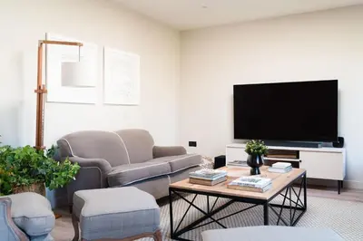a living room with a couch and a tv at Allora in Carbis Bay