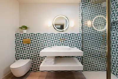 a bathroom with a white sink and a toilet at Allora in Carbis Bay