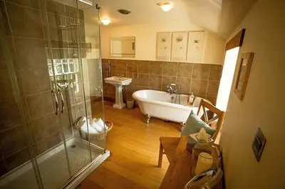 a bathroom with a tub and a shower and a sink at Pencreek in Kea