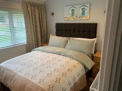 a bedroom with a bed and a window at Seabrook Lodge in Newquay
