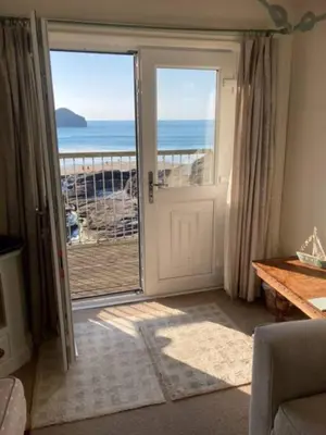 an open door with a view of the ocean at Praxis Trebarwith Strand in Treknow