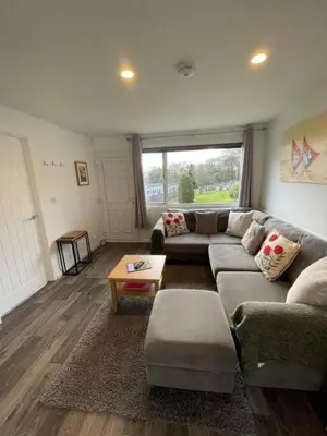 a living room with a couch and a table at Villa 22 Lanteglos Hotel in Lanteglos