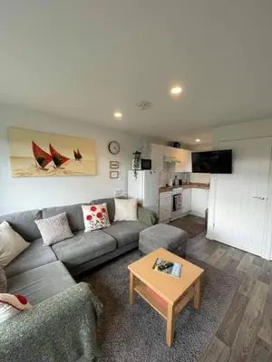 a living room with a couch and a coffee table at Villa 22 Lanteglos Hotel in Lanteglos