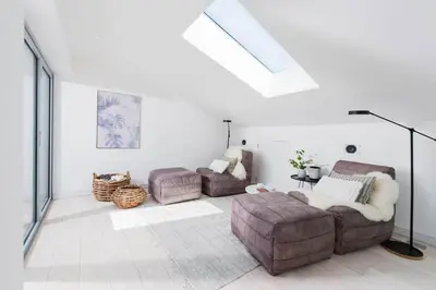 a living room with a couch and a chair at Beachfront Townhouse Lovely Sea Views Newquay in Newquay