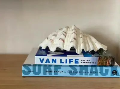 a stack of wan life books sitting on a table at The Palms Cottage Exclusive Use 3 Bedroom Parking Central Newquay in Newquay