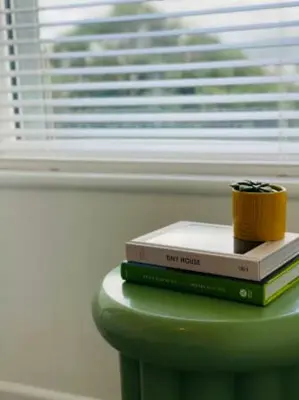 a stack of books sitting on top of a table at The Palms Cottage Exclusive Use 3 Bedroom Parking Central Newquay in Newquay