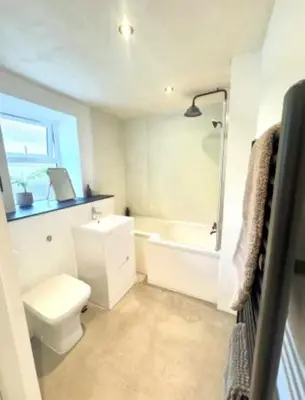 a bathroom with a toilet and a tub and a sink at The Palms Cottage Exclusive Use 3 Bedroom Parking Central Newquay in Newquay