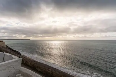 a view of the ocean on a cloudy day at Cosy Beach House on the Seafront Porthleven in Porthleven