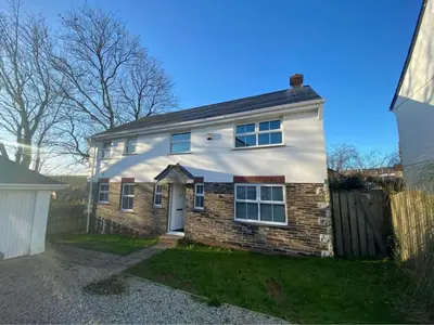 a white house with a brick at The Meadows St Teath 4 bed sleeps 7 in Saint Teath