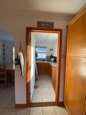 a hallway with a door leading to a kitchen at The Meadows St Teath 4 bed sleeps 7 in Saint Teath