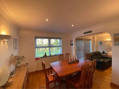 a living room with a wooden table and a couch at The Meadows St Teath 4 bed sleeps 7 in Saint Teath