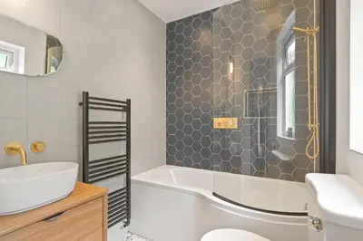 a bathroom with a tub and a sink at Beautiful Home with Sea Views & Parking in Porthtowan