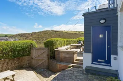 a blue door on the side of a house at Beautiful Home with Sea Views & Parking in Porthtowan